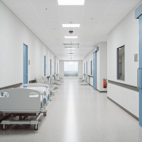 Corridor of an empty modern Japanese hospital with Japanese and English signages.